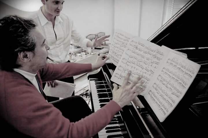 Max Beitan studying a score at the piano with Ivo Pogorelich.